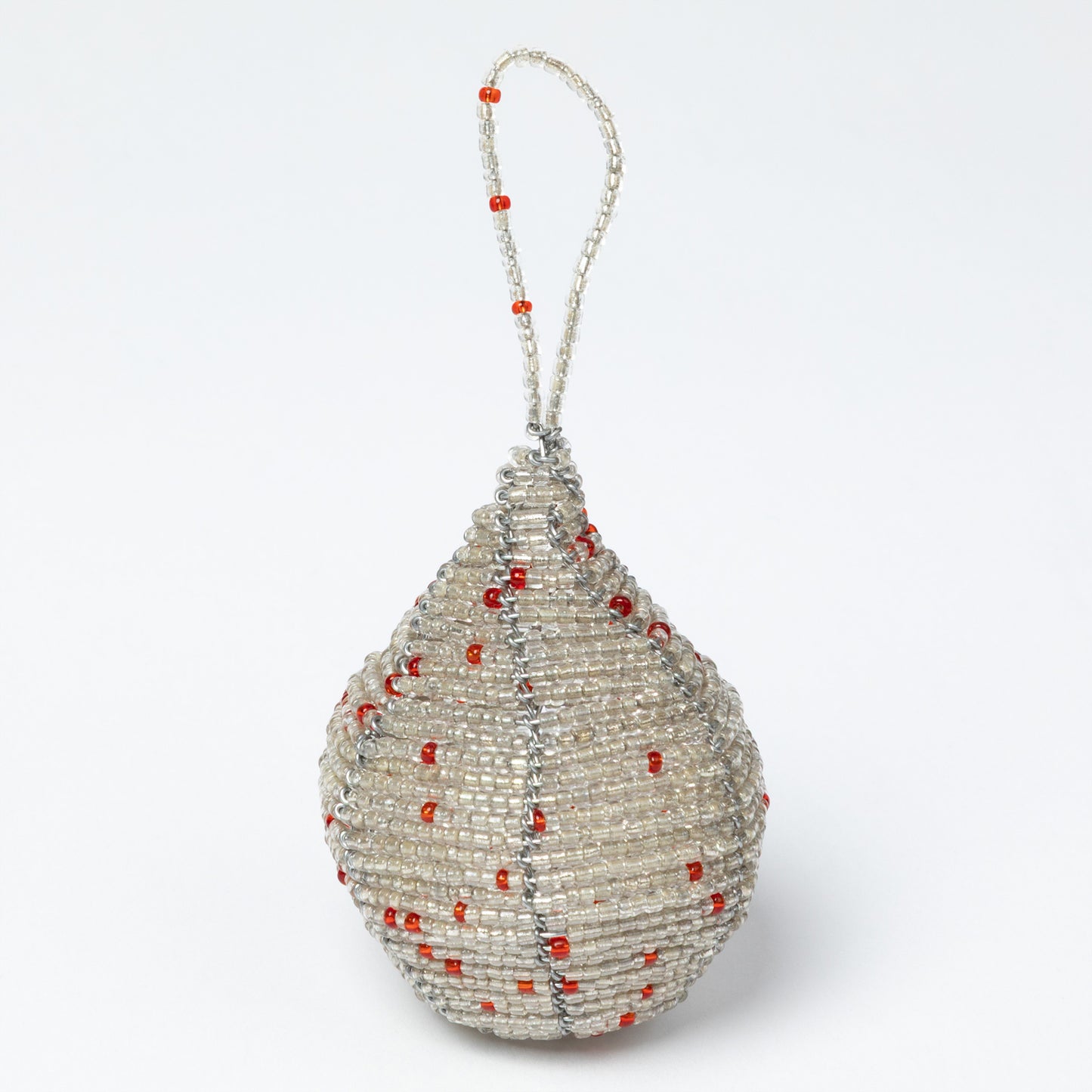 Decorative teardrop ornament with red beads on a white background