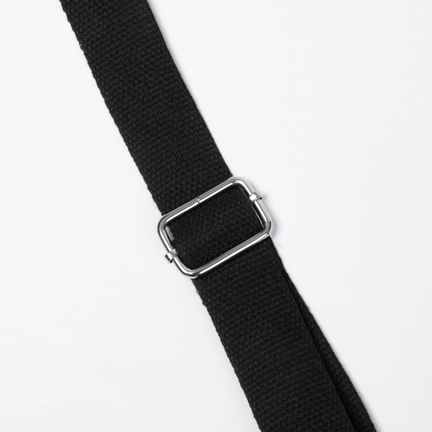 A close-up of a black woven strap with a polished silver metal buckle, shown diagonally on a plain white background.