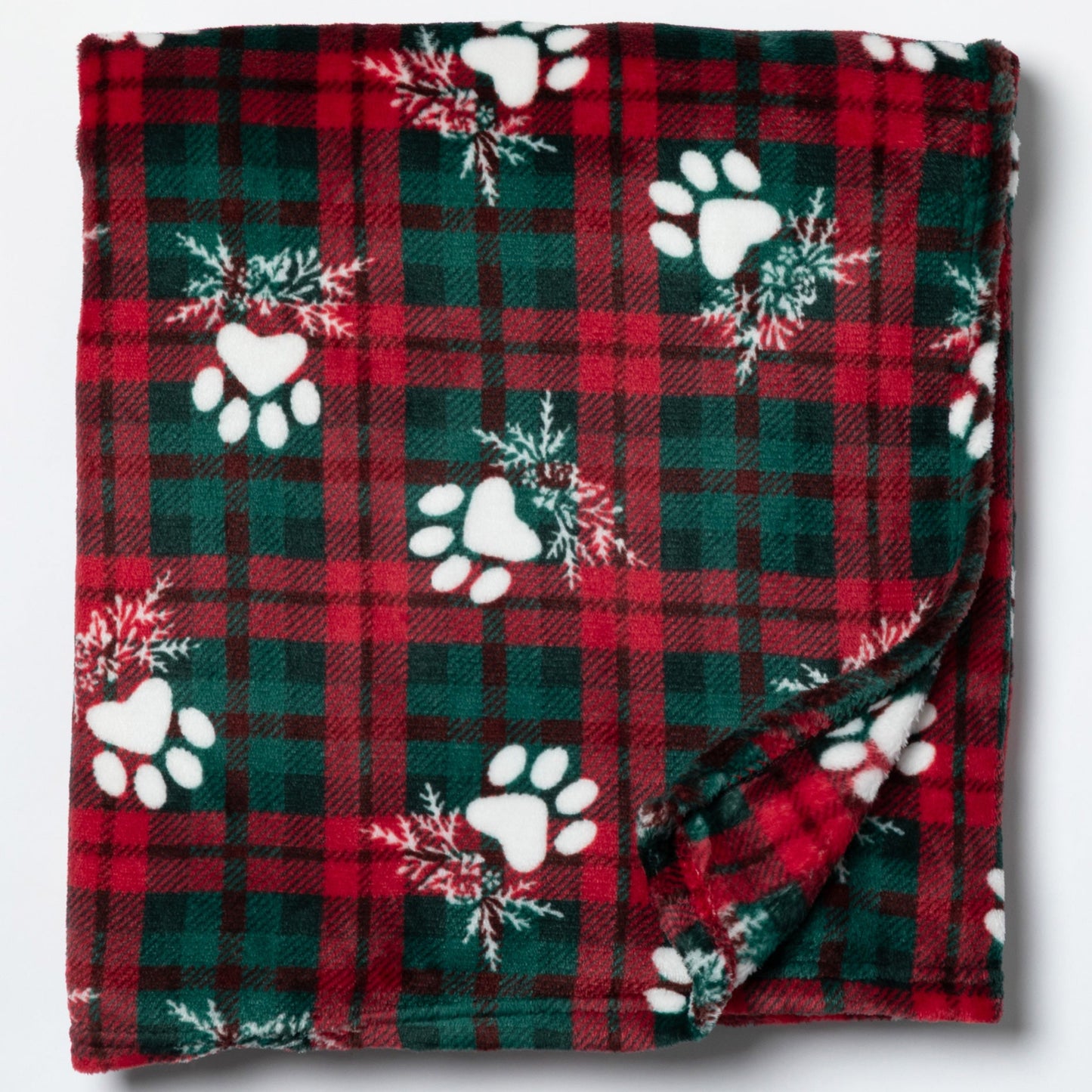 Red and green plaid blanket with white paw prints and snowflakes on a white background