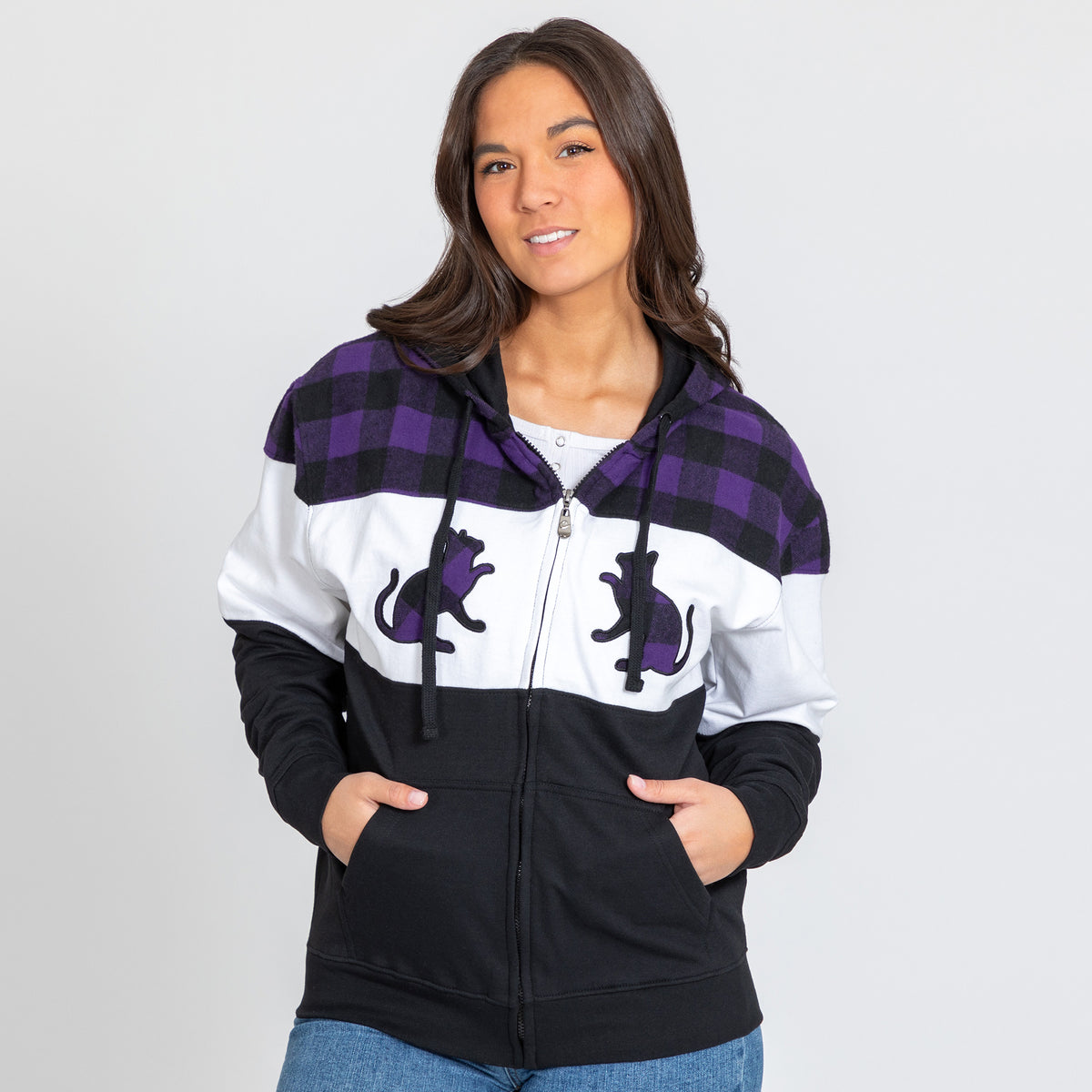 A woman wearing a purple plaid zip hoodie with two cat silhouettes on the front, with a white background.