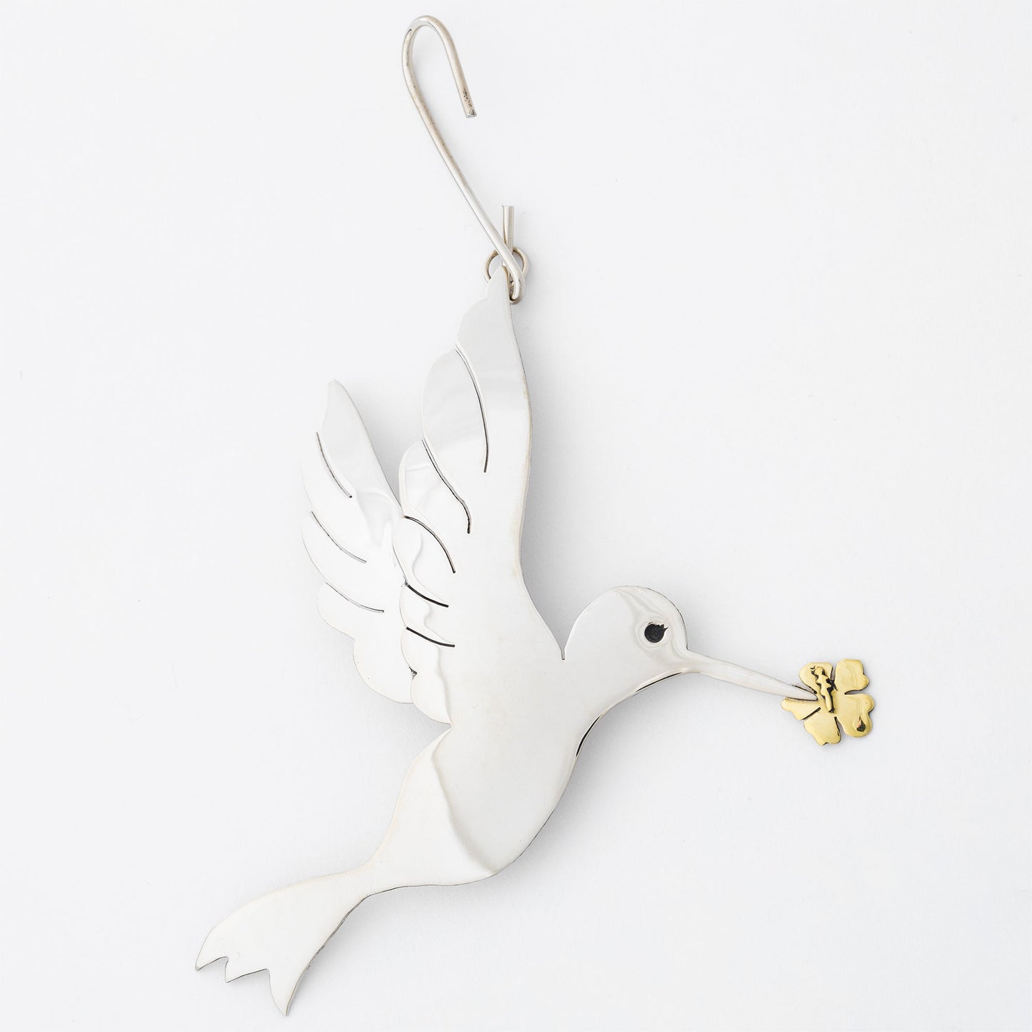 Silver tone dove ornament with gold olive branch on a white background