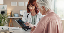 female doctor looking at brain scan with elderly patient