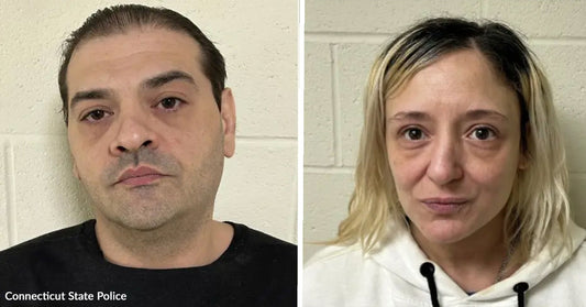 Side-by-side mugshots of a man in a black shirt and a woman in a white hoodie against a light-colored wall.