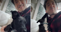 On the left, a smiling man holds a small black-and-white puppy indoors; on the right, the same man cuddles the puppy while it licks his cheek.