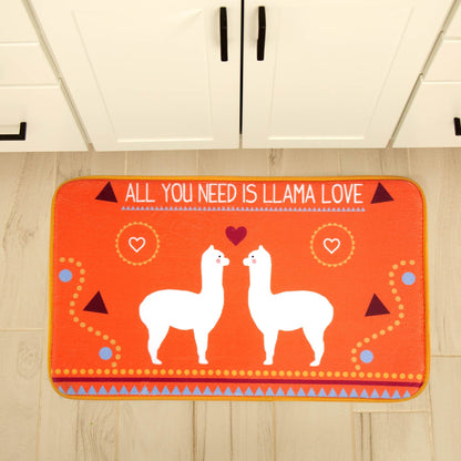 Orange rug with llamas and the phrase 'All you need is llama love' on a wooden floor.
