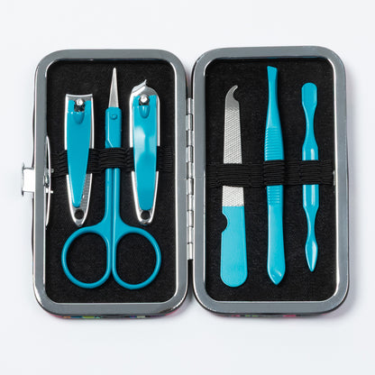 A nail care set in a rectangular metal case, shown open on a white background. The set includes turquoise blue nail scissors, nail clippers, a cuticle scraper, a nail file, and a small brush, arranged in black foam compartments.