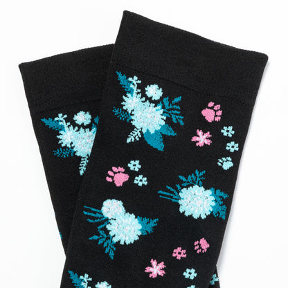 Black compression socks with floral and paw print patterns on a white background