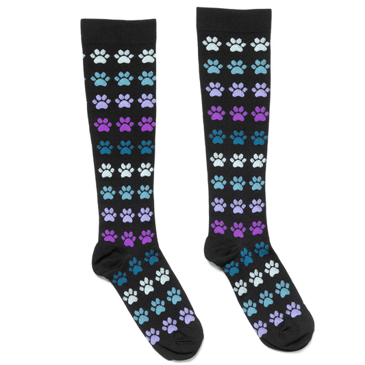 A pair of compression socks with varying paw print designs, displayed in colors black, white, blue, green, and purple.