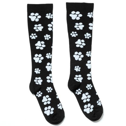 A pair of black compression socks with a white paw print design, against a white background.