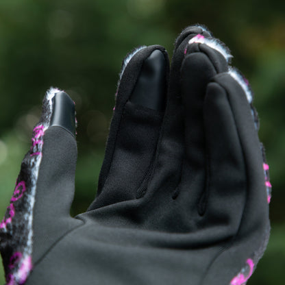 The touchscreen technology fingertips located on the index finger and thumb on a warm black fleece glove adorned with prink and violet elegant paw prints. 