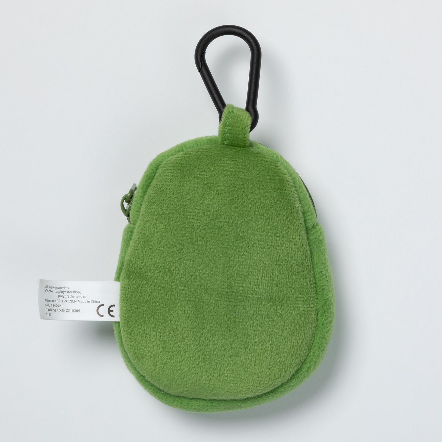 Green plush avocado-shaped keychain with a carabiner for pet waste bags on a light gray background.