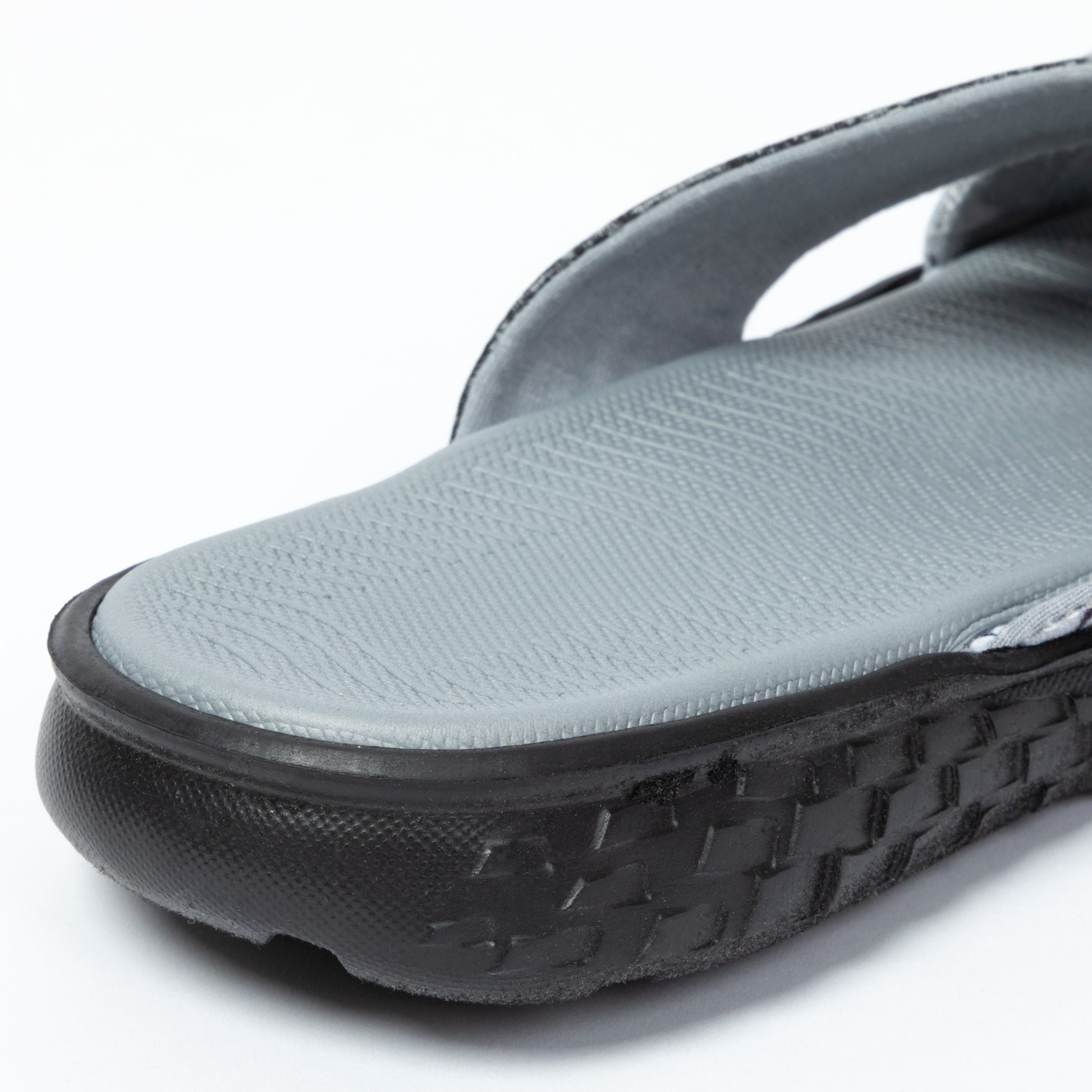 Gray sandal with black sole on a white background