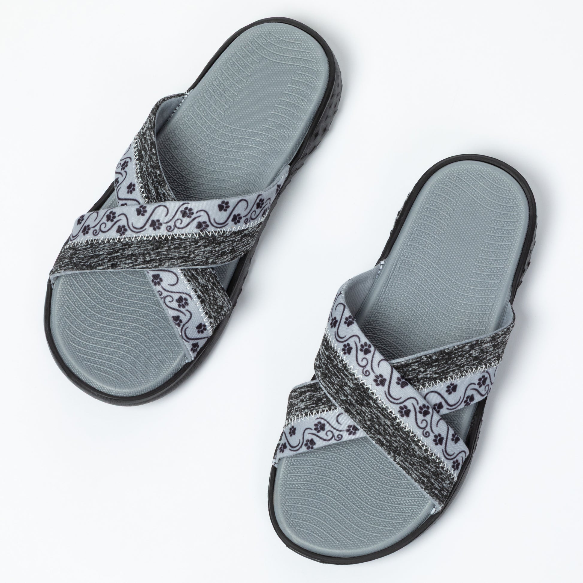 Pair of gray sandals with patterned straps on a white background