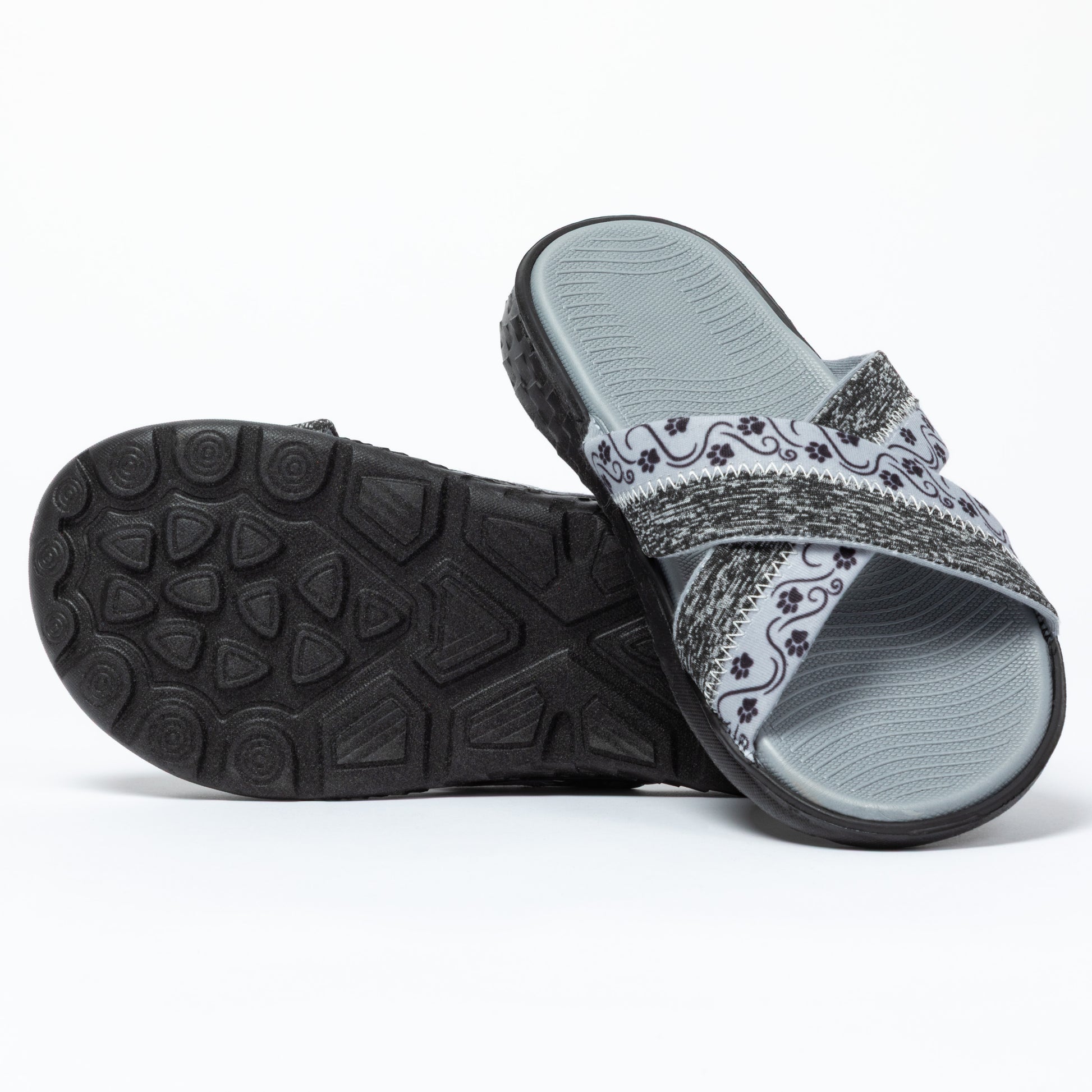 Gray slide sandals with paw patterned strap on a white background with a black traction sole