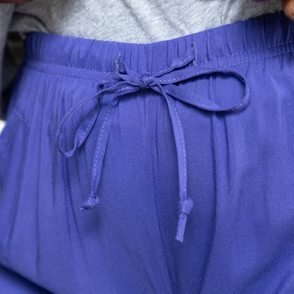 Close-up of a person wearing periwinkle shorts with a drawstring.