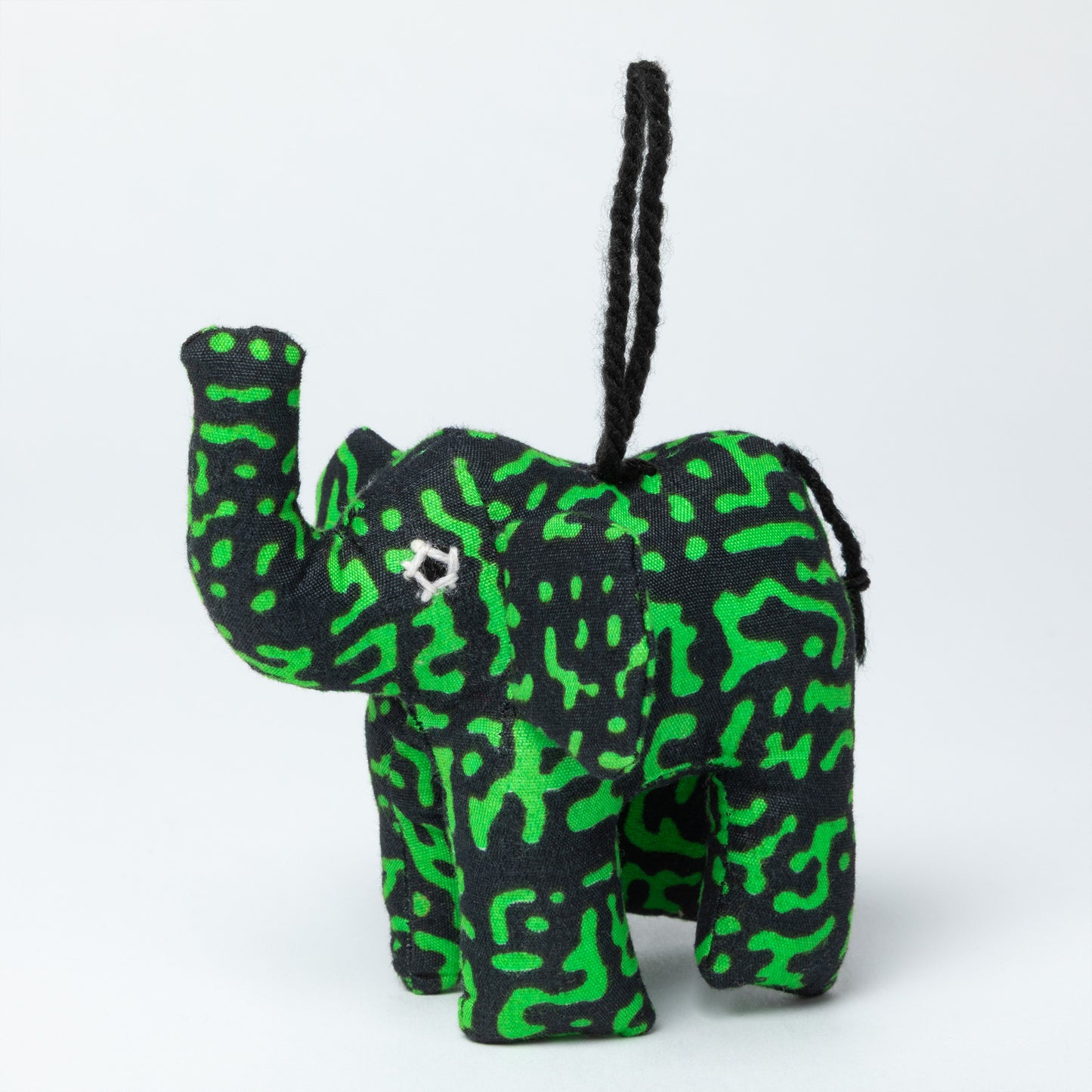 Green and black patterned elephant ornament on a white background