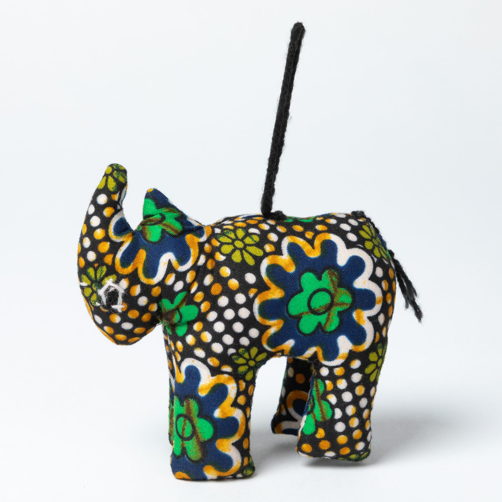 Colorful rhinoceros-shaped ornament with floral patterns on a white background