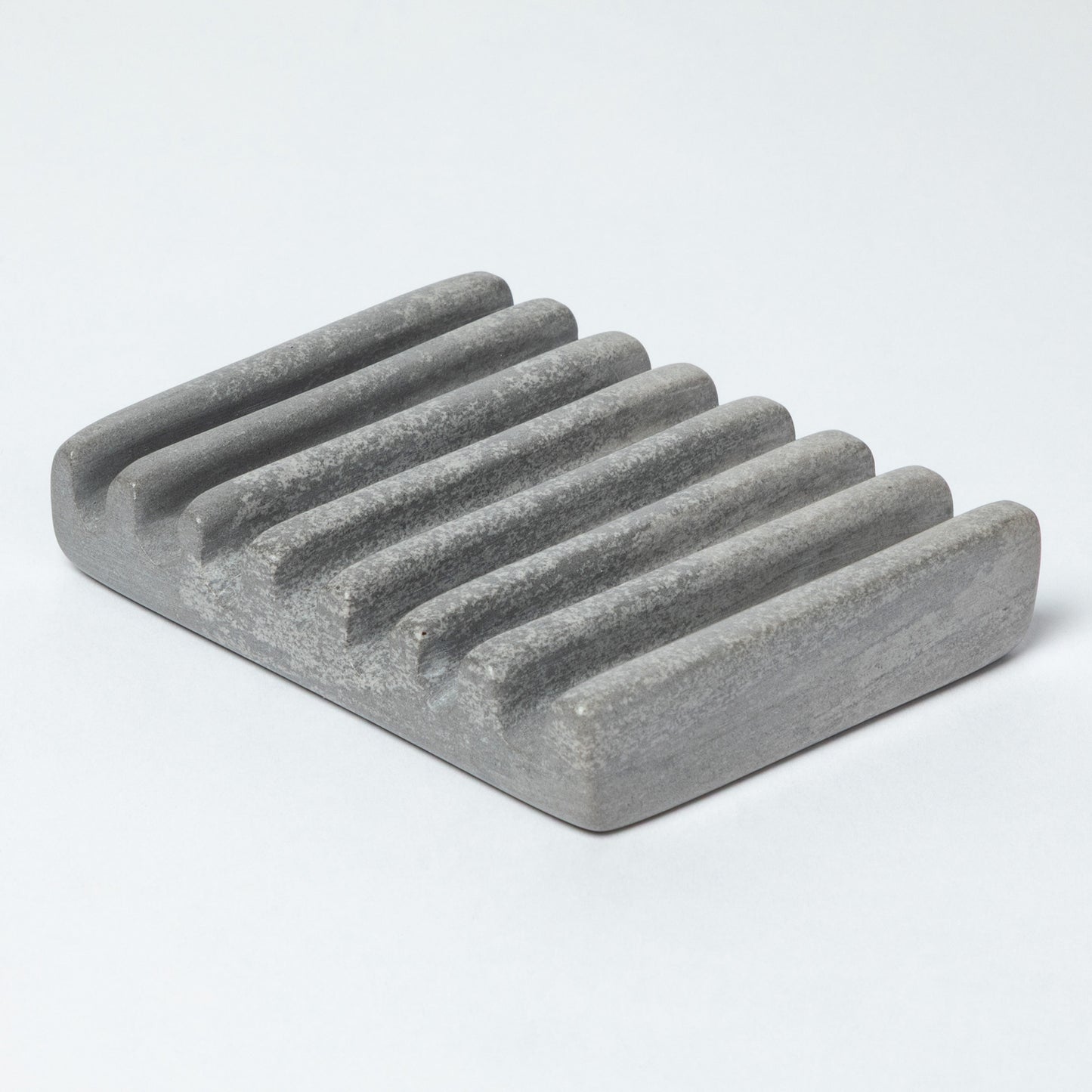 Gray stone soap dish on a light gray background
