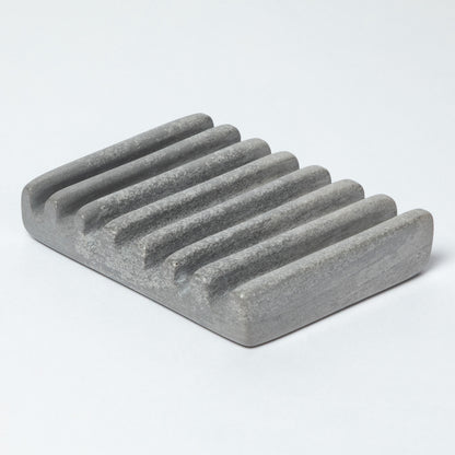 Gray stone soap dish on a light gray background