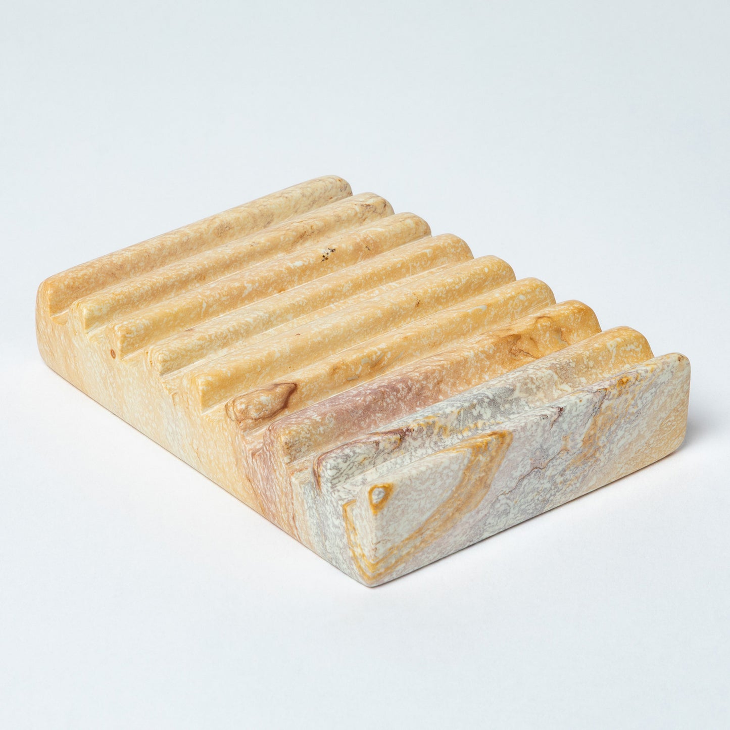 Rectangular soapstone soap dish with ridges and a natural marbled pattern on a white background.