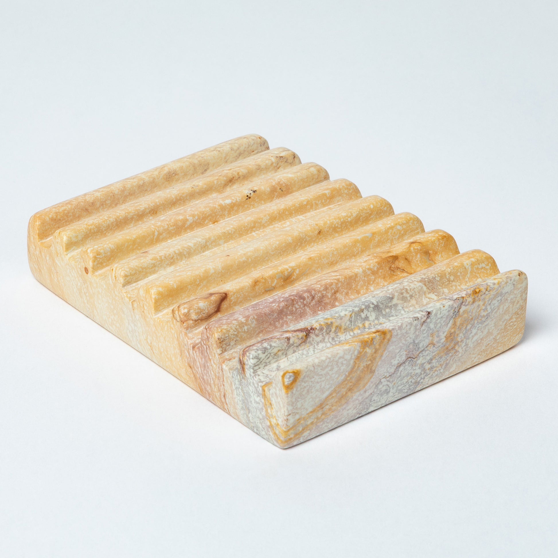 Rectangular soapstone soap dish with ridges and a natural marbled pattern on a white background.