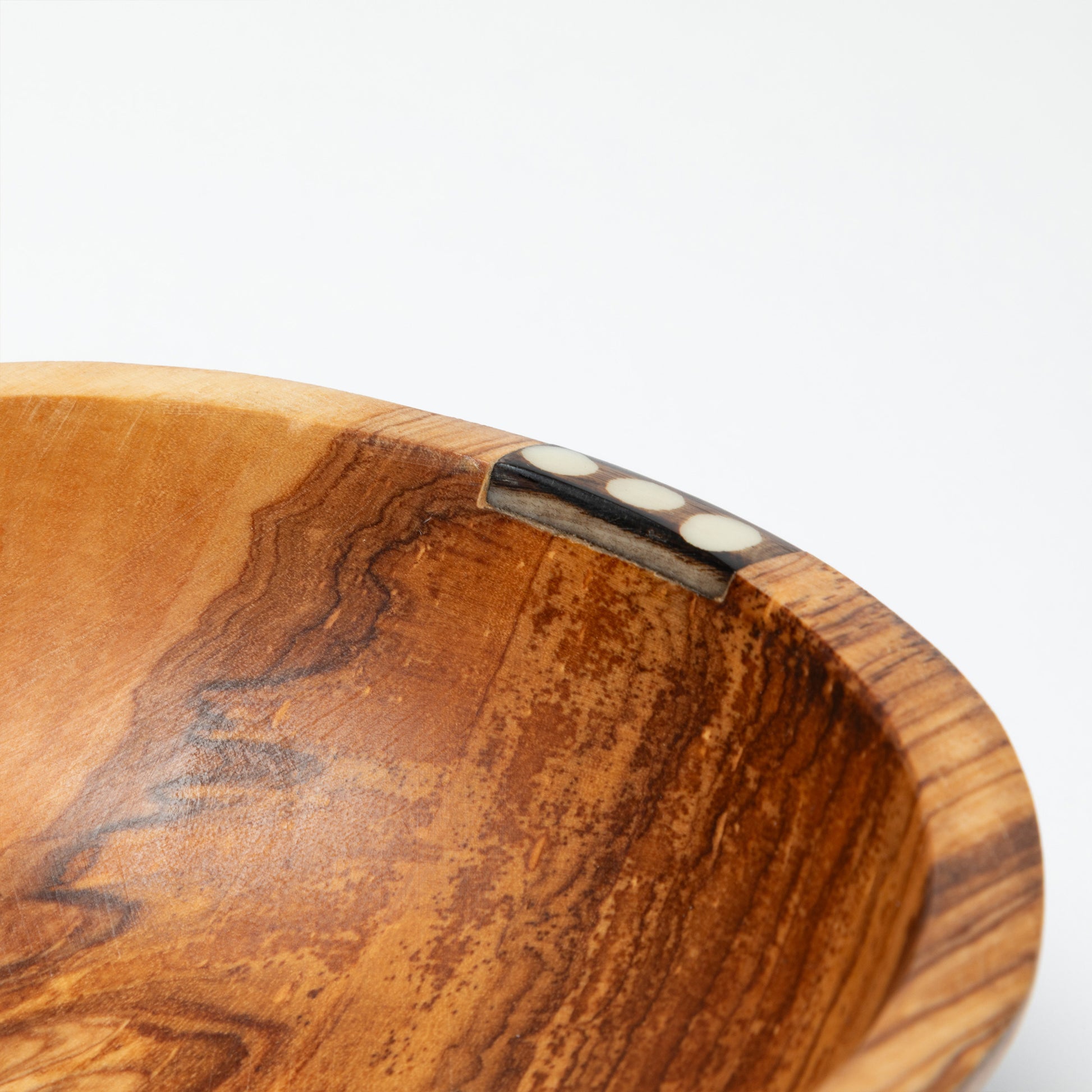 Close-up of a wooden bowl with a white background
