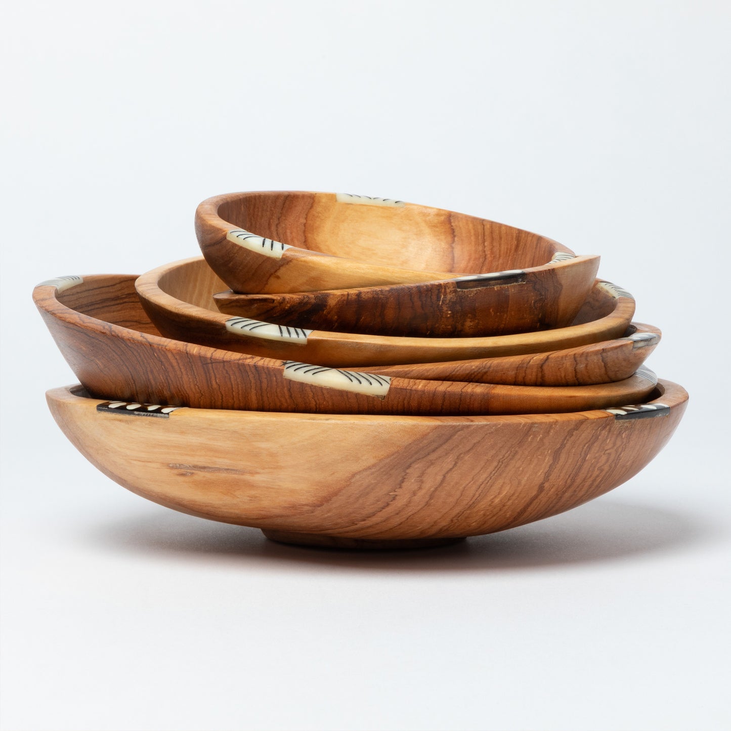 Set of wooden bowls of different sizes on a white background