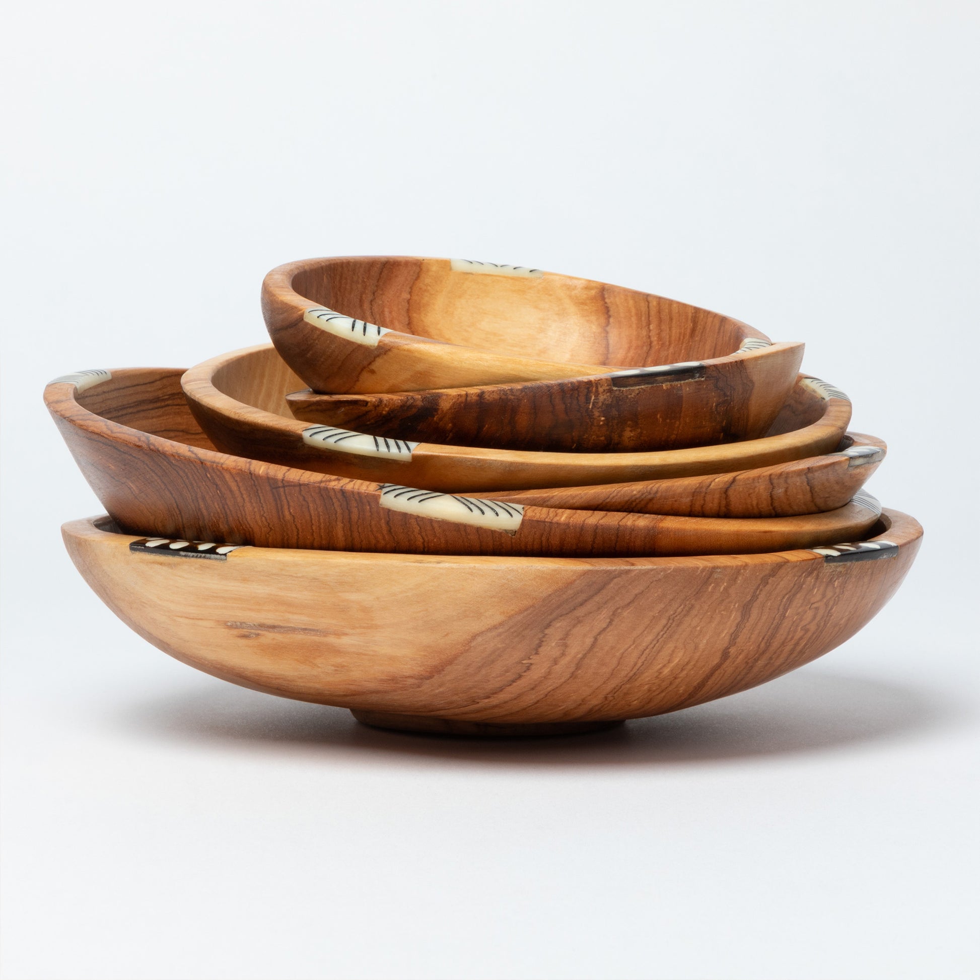 Set of wooden bowls of different sizes on a white background