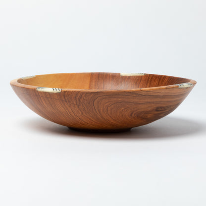 Wooden bowl with a wavy grain pattern on a white background