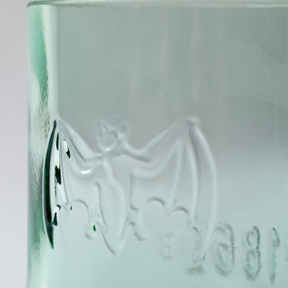 Green glass with embossed design on a white background