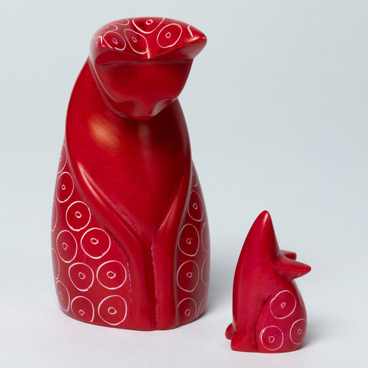 Red soapstone cat and mouse figurines with white circular patterns on a white background