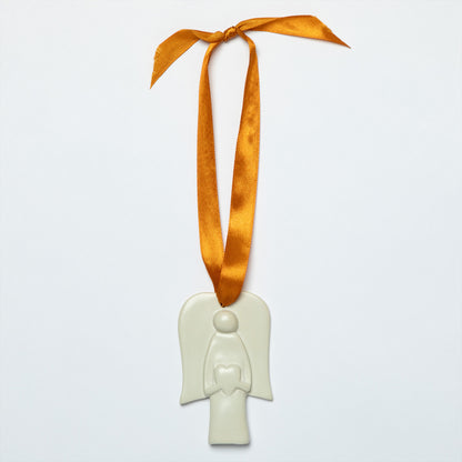 White angel ornament with an orange ribbon on a light gray background