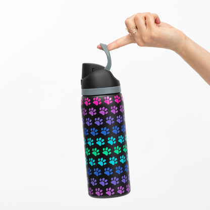 Water bottle with colorful paw pattern held by a hand on a white background