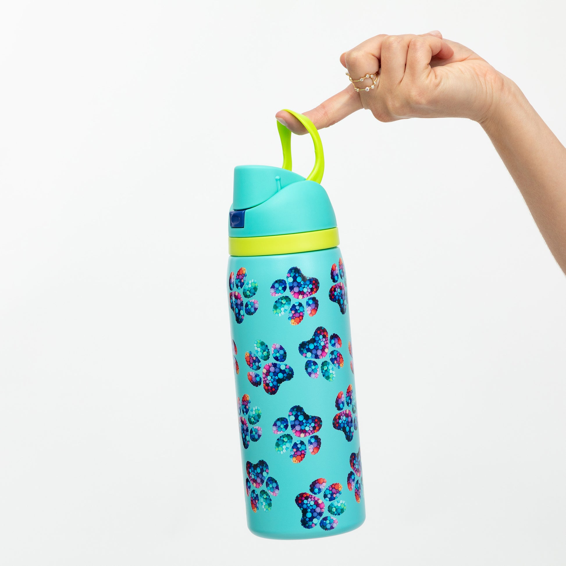 Turquoise water bottle with colorful floral pattern and yellow handle held by a hand on a white background