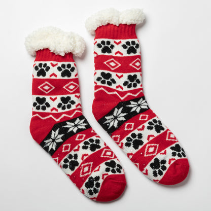 Pair of red, black white Sherpa Fleece Lined Paw Print Cabin Slipper Socks with sherpa trim on a light gray background alpine fair isle paws red 