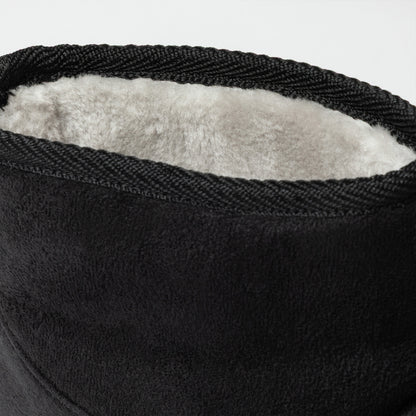 Close-up of a black shoe with white lining on a light gray background