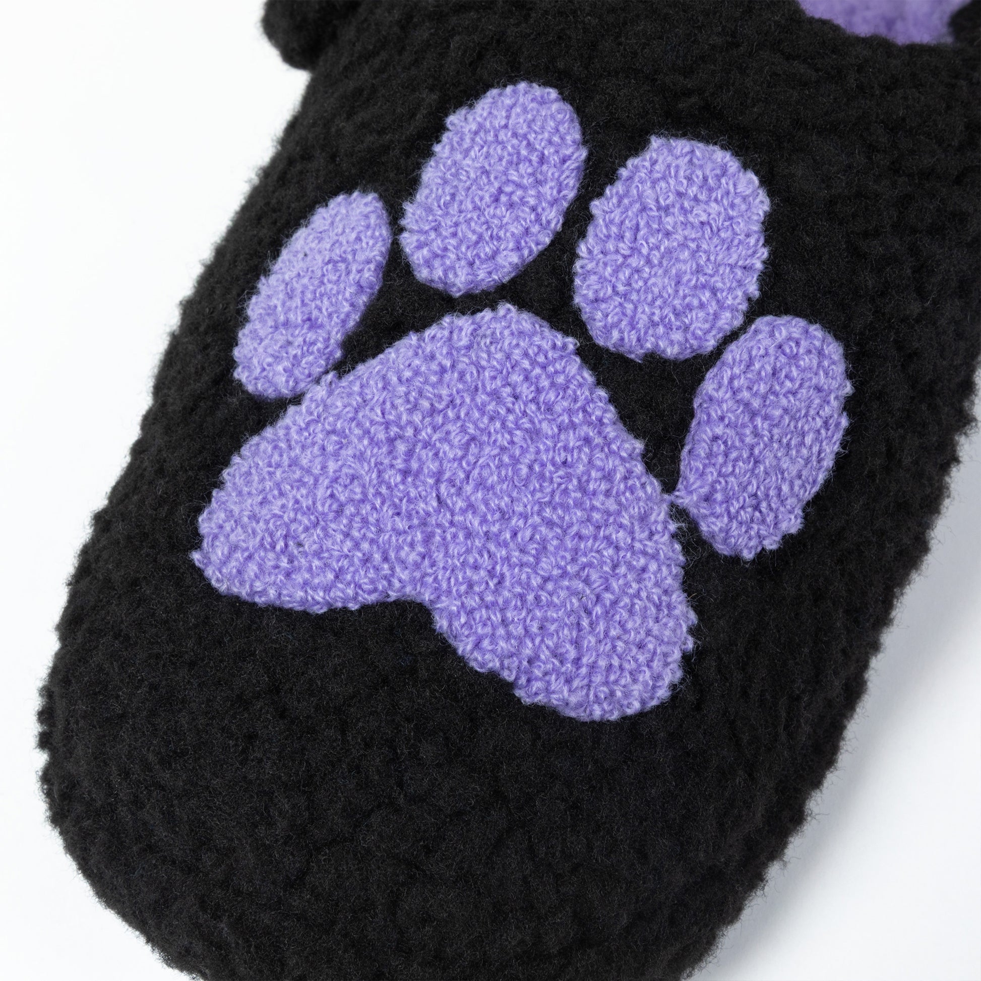 Black slipper with a purple paw print on a white background