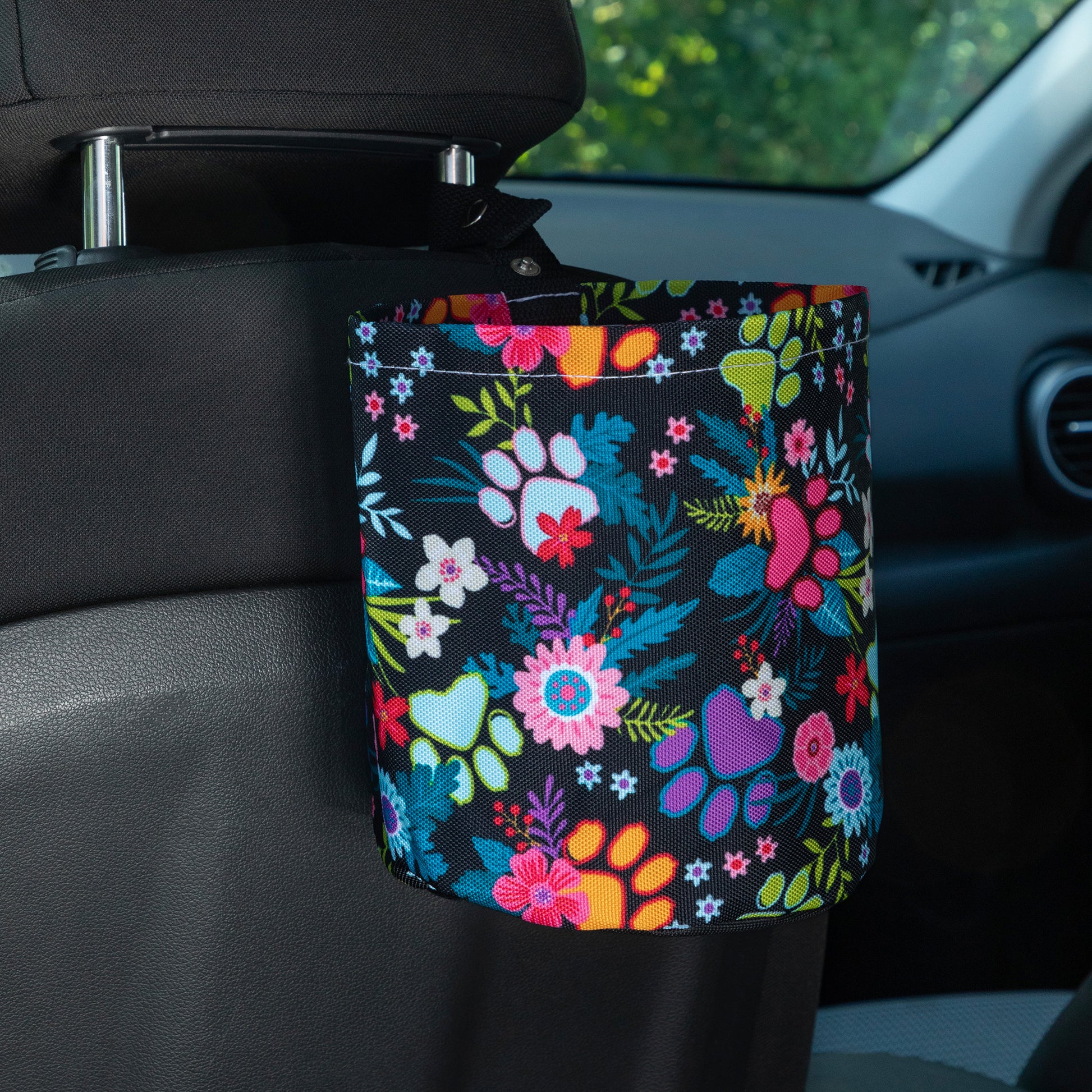 Floral-patterned car garbage holder attached to a car seat.