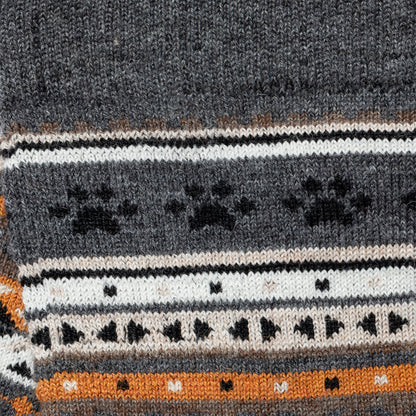 Close-up of a knitted fabric with a pattern featuring black paw prints on a gray background.