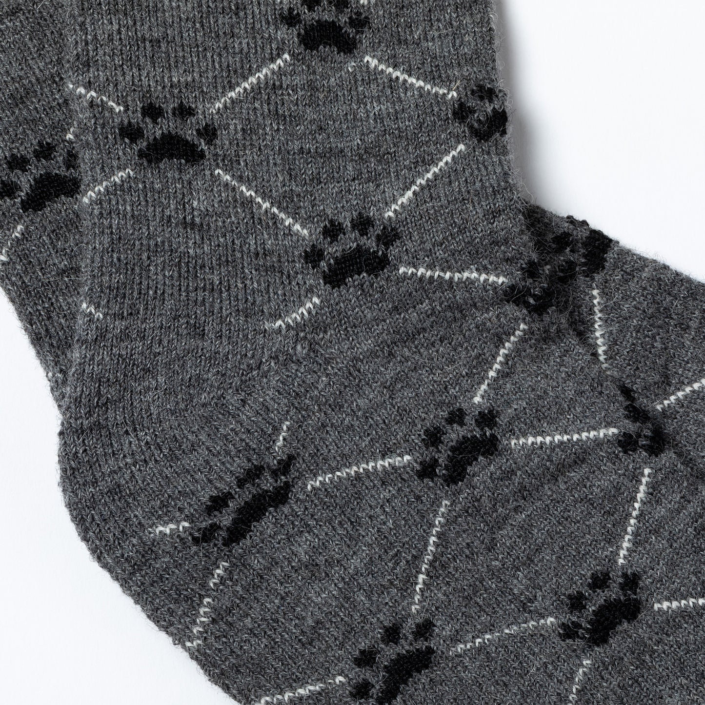 Gray socks with black paw print pattern on a white background