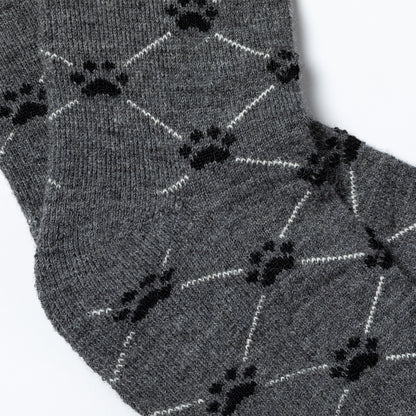 Gray socks with black paw print pattern on a white background