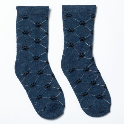 Pair of blue socks with black paw print pattern on a white background
