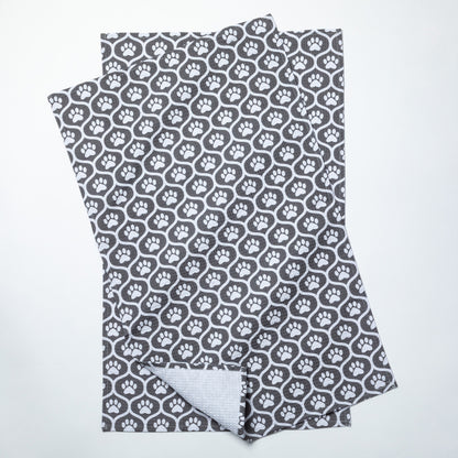 Folded fabric with gray paw print pattern on a white background