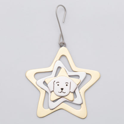 A metal ornament shaped like a star, featuring concentric star layers in gold, silver, and white, with a small white dog face charm in the center, shown on a light gray background.
