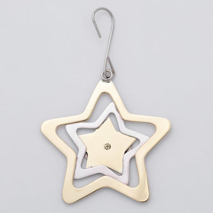 A three-tiered star-shaped ornament in gold, silver, and white gold, suspended from a silver hook on a light gray background.