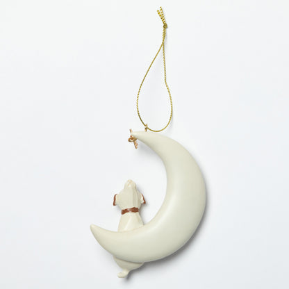 Decorative hanging ornament with a moon and dog design on a white background