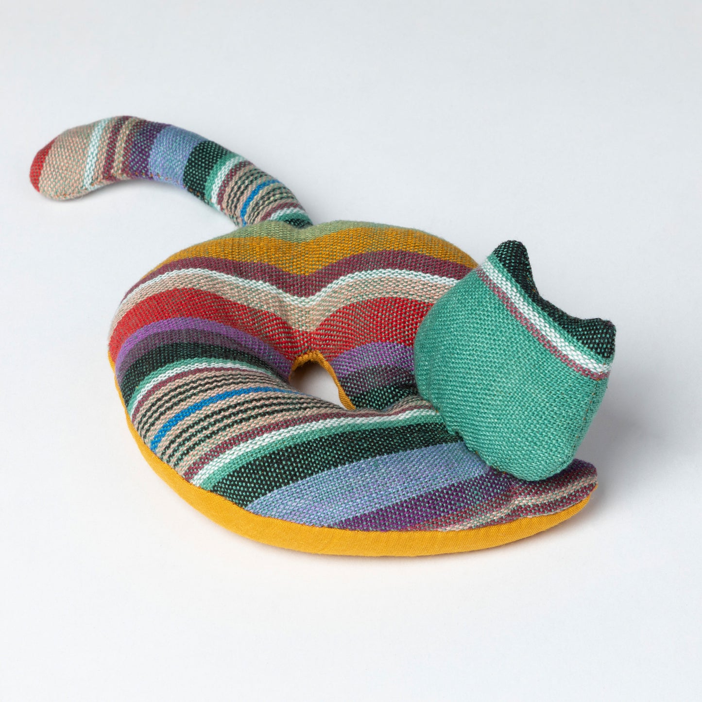 Colorful knitted cat coaster on a white background