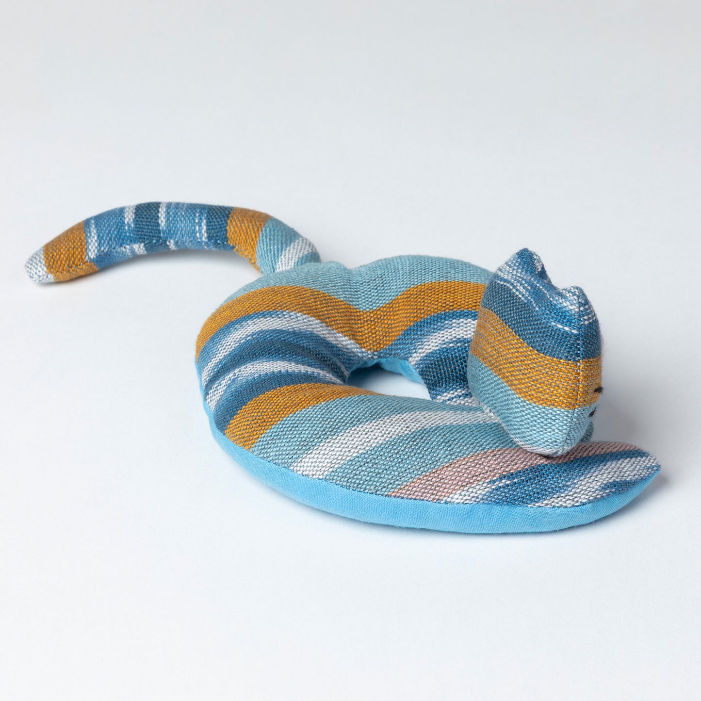 Striped cat shaped coaster on a white background