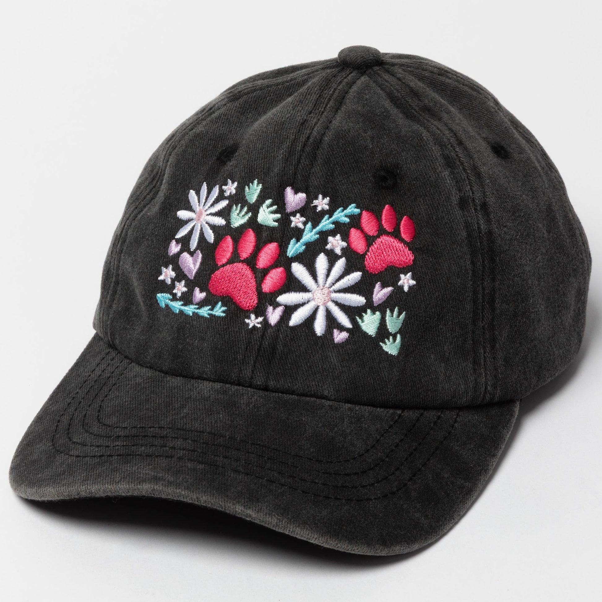 Black cap with floral and paw print design on a light gray background