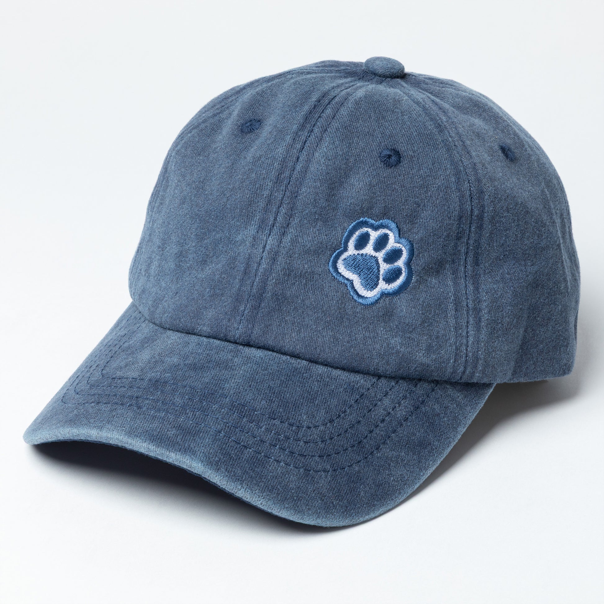 Blue cap with a paw print design on a light gray background